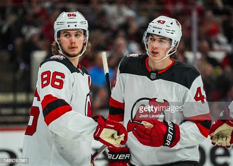 Luke Hughes and Jack Hughes of the New Jersey Devils talk during the... News Photo - Getty Images