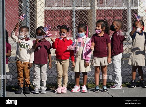 Students at Carrie P. Meek/Westview K-8 Center in Miami, wave at a funeral motorcade carrying ...