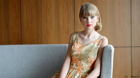 Taylor swift is sitting on the sofa in the background wall wood pattern 4K wallpaper download