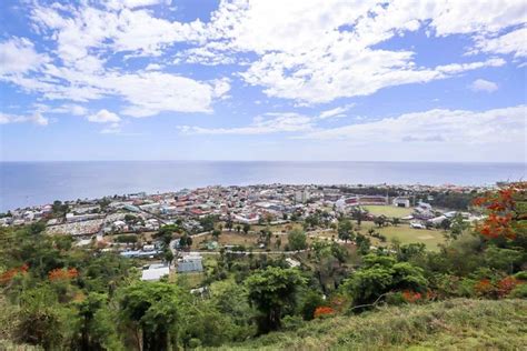 an aerial view of a city with trees and water in the background on a ...