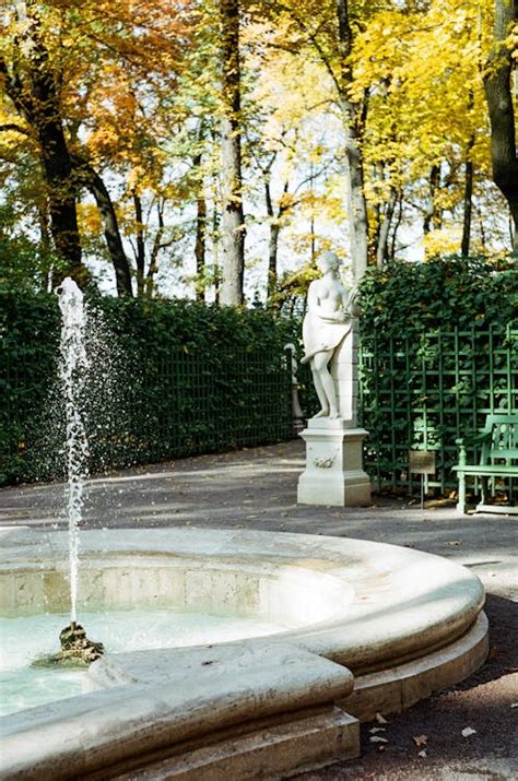 Photograph of a Fountain Near a Sculpture · Free Stock Photo