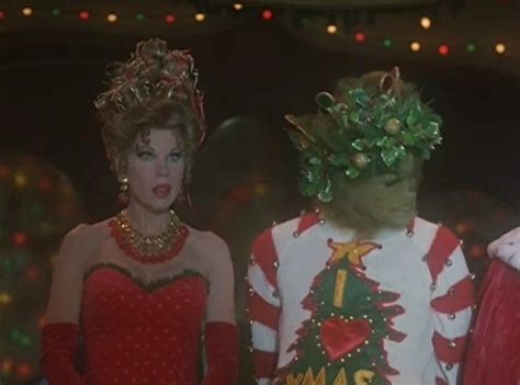 two women dressed in christmas costumes standing next to each other with their hands on their hips