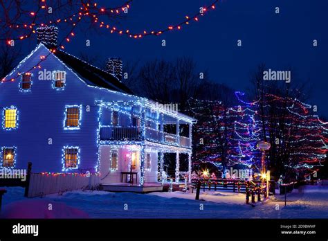 Heritage buildings, trees and fences decorated with Christmas lights at ...