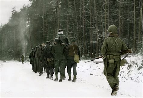 Soldiers of the US. 70th Infantry Division lead a column of captured ...