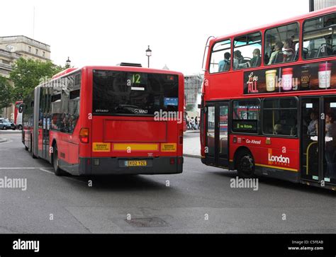 A bendy bus and double decker bus in traveling London Stock Photo - Alamy