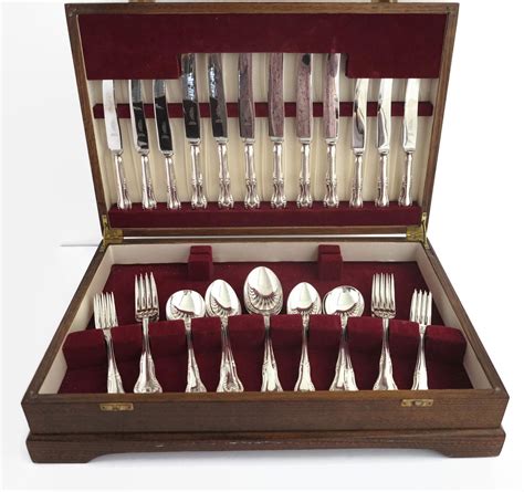 Mid 20th century canteen of 38 pieces of silver plated and stainless steel cutlery in wooden ...