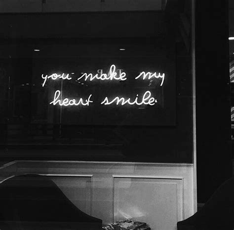 a neon sign that says you make my heart smile on the wall in front of a ...