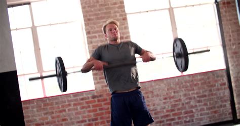 Young man doing power clean exercise during gym workout 1289679 Stock ...