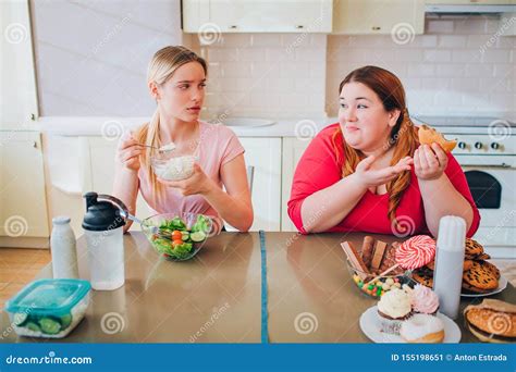 Confused Young Slim Model Eat Farmer Cheese at Table. she Look at Plus ...