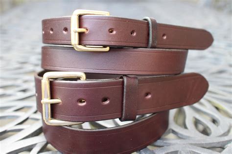 A couple of my solid brass roller buckle full grain veg tan leather belts handmade by me ...