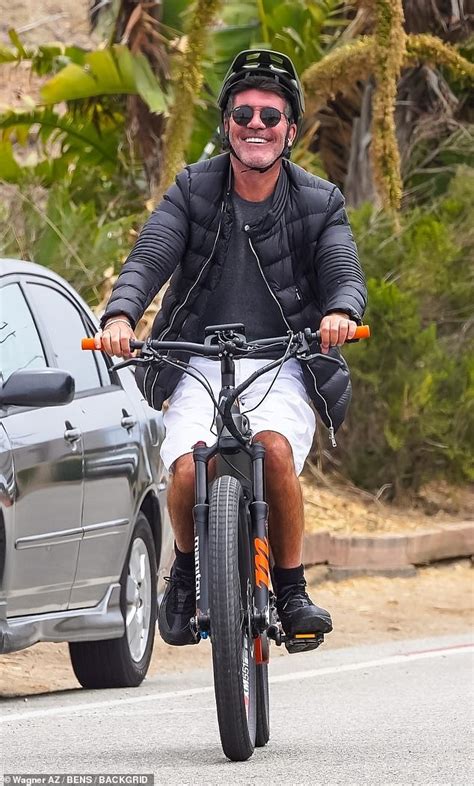 Simon Cowell flashes a smile while taking a cruise around Malibu on his ...