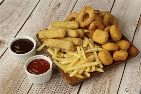 Freshly Cooked Snack Platter of French Fries, Cheese Sticks, Onion Rings and Chicken Nuggets ...