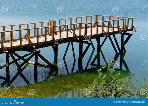 Catching Fish on Wooden Pier by the Lake Stock Photo - Image of lake ...