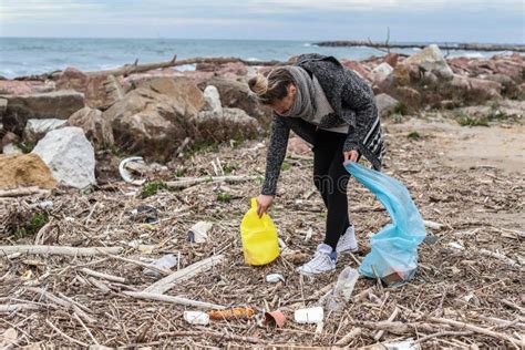 Young Girl Picking Up Trash from the Beach. Stock Photo - Image of ...