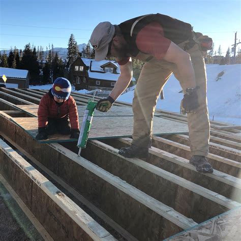 Starting to build up: Installing the first steel beam, floor joists and ...