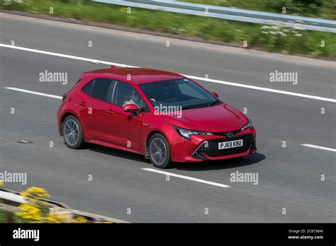 2019 Toyota Corolla Design Vvt-I Red Car Hatchback Hybrid Electric driving on the M6 motorway ...