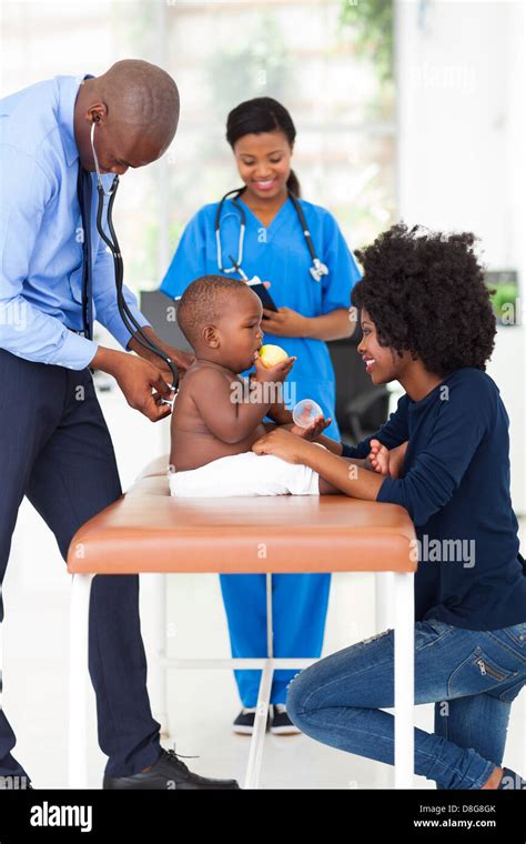 male African American pediatrician examining baby boy Stock Photo - Alamy