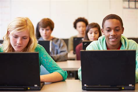 Group Of High School Students In Class Using Laptops - LearnSafe