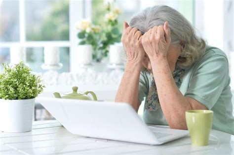 Premium Photo | Portrait of beautiful senior woman sitting at table with laptop