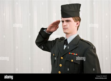 Young man in retro army uniform saluting Stock Photo - Alamy