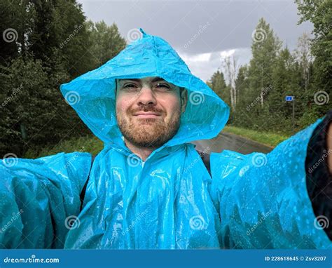 A Man in a Blue Raincoat Takes Pictures with a Smartphone in a Autumn Rainy Forest Stock Image ...