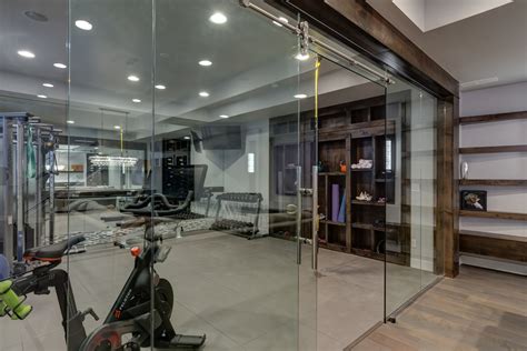 Basement Gym Workout with Glass Walls - Unique Transitional Home Gym Design by FBC Remodel | Houzz