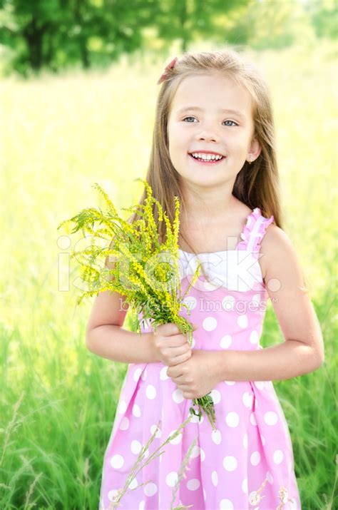 Portrait Of Adorable Smiling Little Girl With Flowers Stock Photo ...