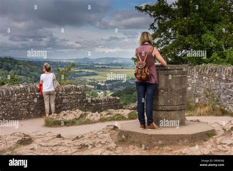 Symonds Yat Rock viewpoint, Gloucestershire, UK. One woman surveying ...