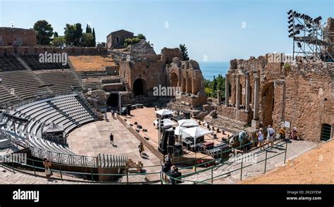 Tourists exploring old ruins of ancient Greek theater during summer vacation Stock Photo - Alamy