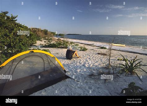 Canoeist camping on beach at Picnic Key in Ten Thousand Islands area in Everglades National Park ...