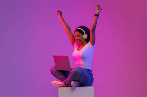 Premium Photo | Online Win Happy Black Woman Celebrating Success With Laptop In Neon Light