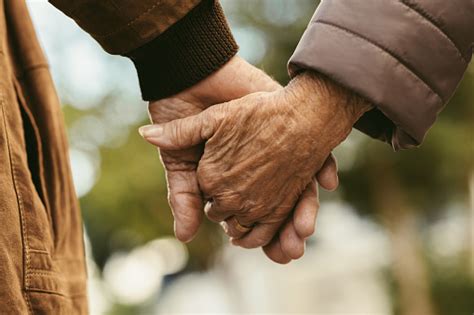 Elderly Couple Holding Hands And Walking Stock Photo - Download Image ...