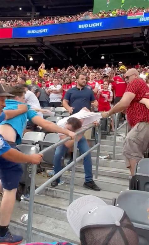 Footage shows fans fight in the stands as Manchester United beat ...