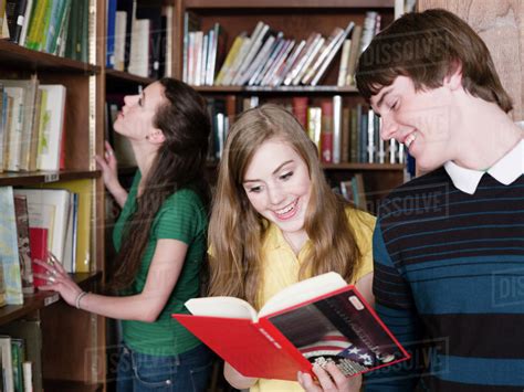 Students reading books in library - Stock Photo - Dissolve