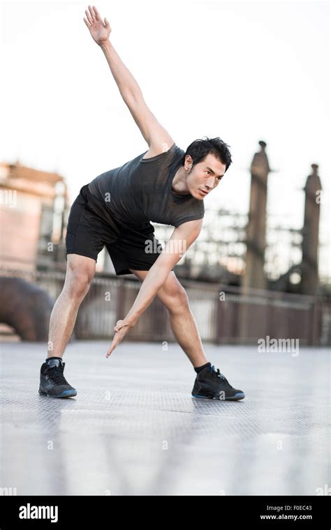 Young man exercising outdoors Stock Photo - Alamy