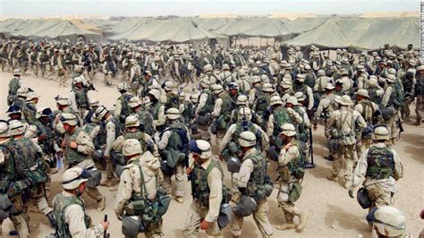 U.S. Marines in northern Kuwait gear up after receiving orders to cross the Iraqi border on ...