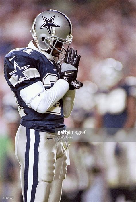 Cornerback Deion Sanders of the Dallas Cowboys prays while standing ...