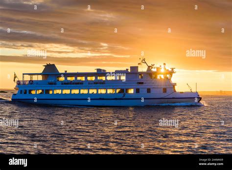 Ferry at sunset Stock Photo - Alamy