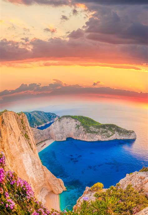 Navagio+beach+with+shipwreck+and+flowers+against+sunset+on+Zakynthos ...