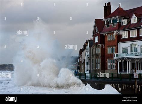 Rough North sea conditions create a spectacular sight as waves break against the seafront at ...