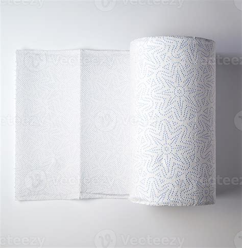 expanded white roll of kitchen paper towel on a white background ...