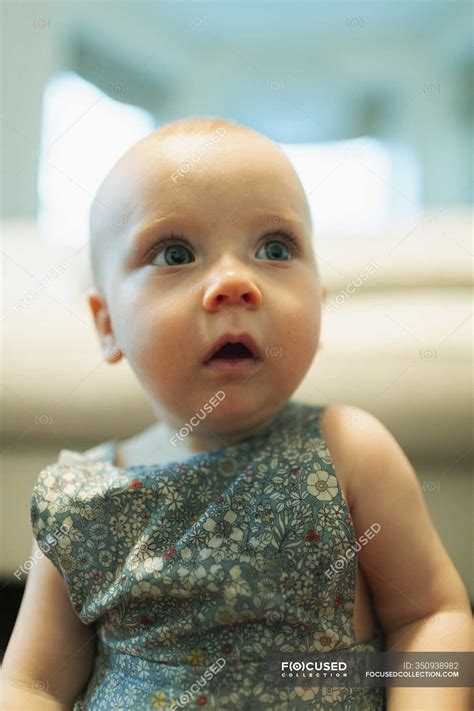 Cute curious baby girl looking away — one person, innocence - Stock ...