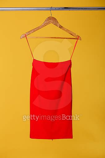 women's red skirts on wooden hangers on rank on orange backgroun 이미지 ...