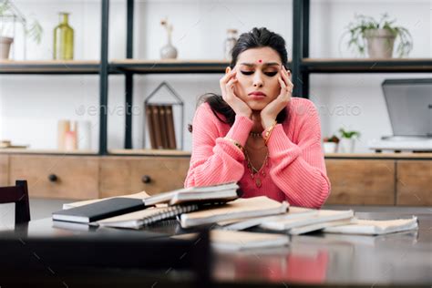 sad indian student with bindi studying at home with books Stock Photo ...