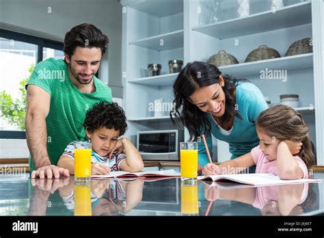 Parents helping their children doing homework Stock Photo - Alamy