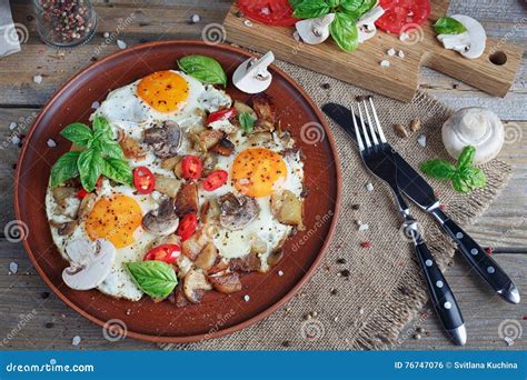 Fried Eggs with Mushrooms, Tomatoes and Basil on Rustic Wooden T Stock ...