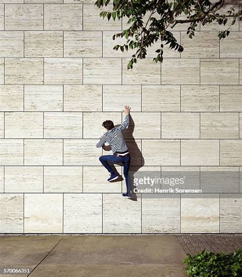 Man Climbing Building Photos and Premium High Res Pictures - Getty Images