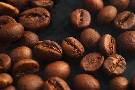 Premium Photo | Coffee beans on a black background coffee on a black ...