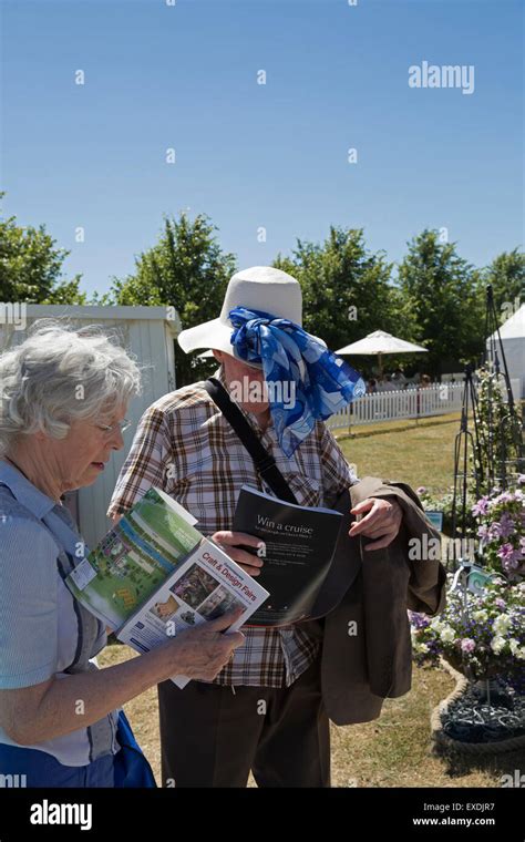 A couple look at a map at the Hampton Court Palace Flower show Stock Photo - Alamy