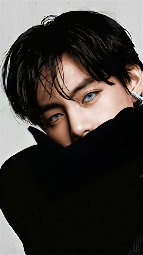 a man with black hair and blue eyes